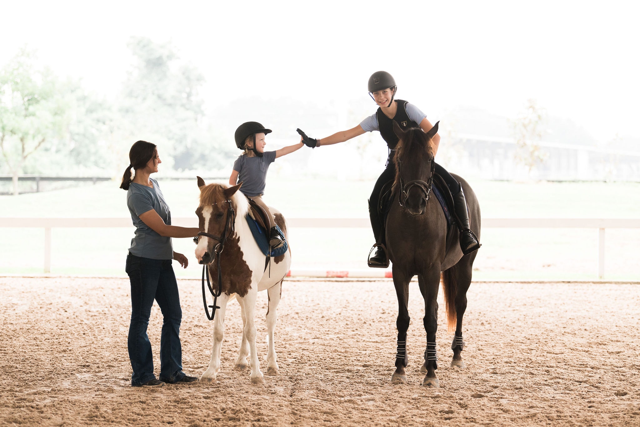 Young riders, instructors, and ponies together in the Austin arena